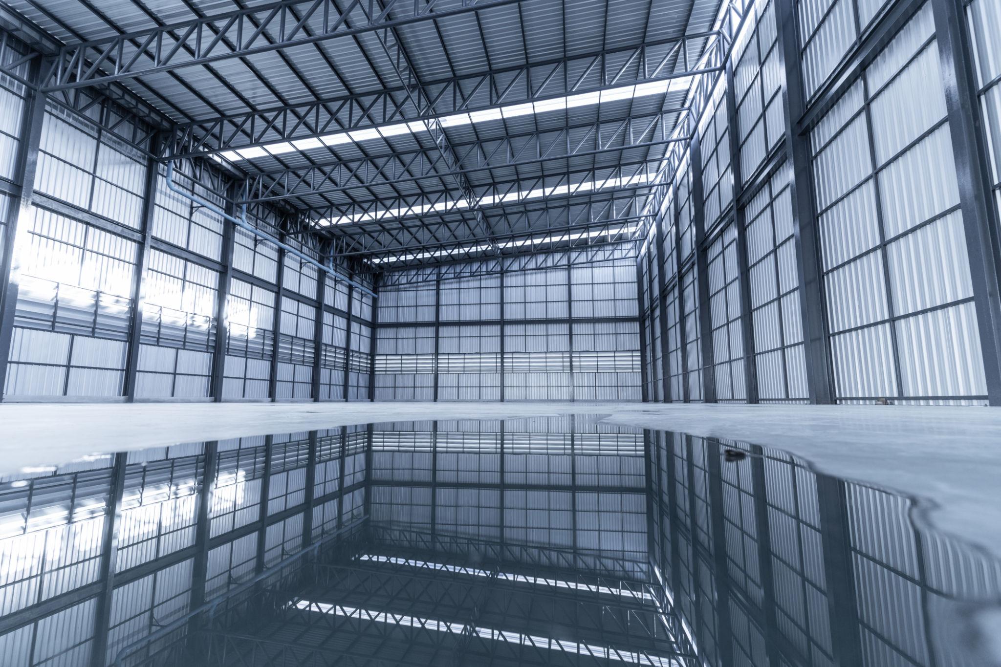 Industrial steel structure framework inside fabrication facility with heavy-duty beams
