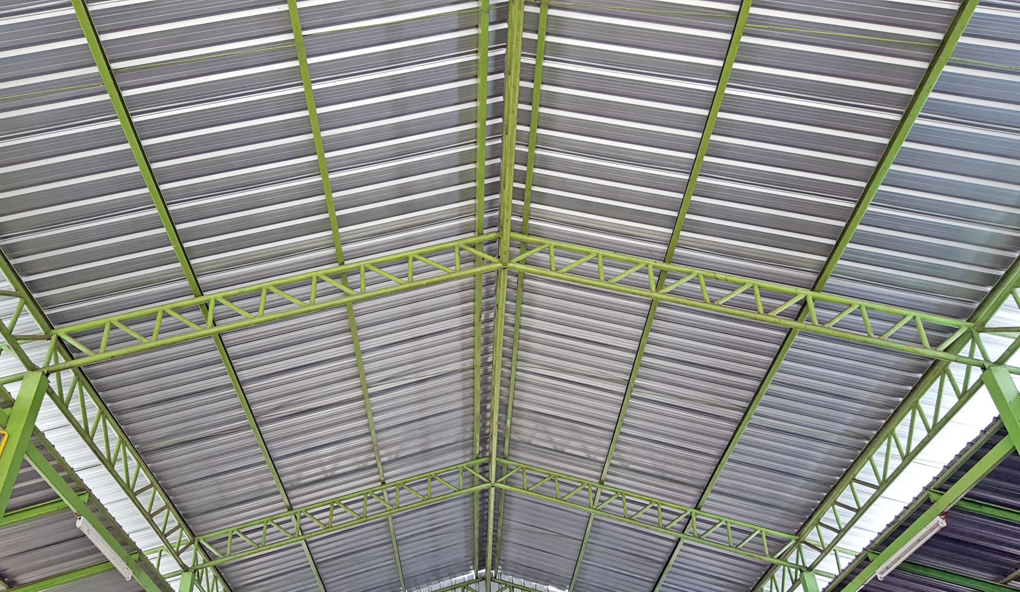 Industrial roofing steel structure with metal sheet installation and support beams