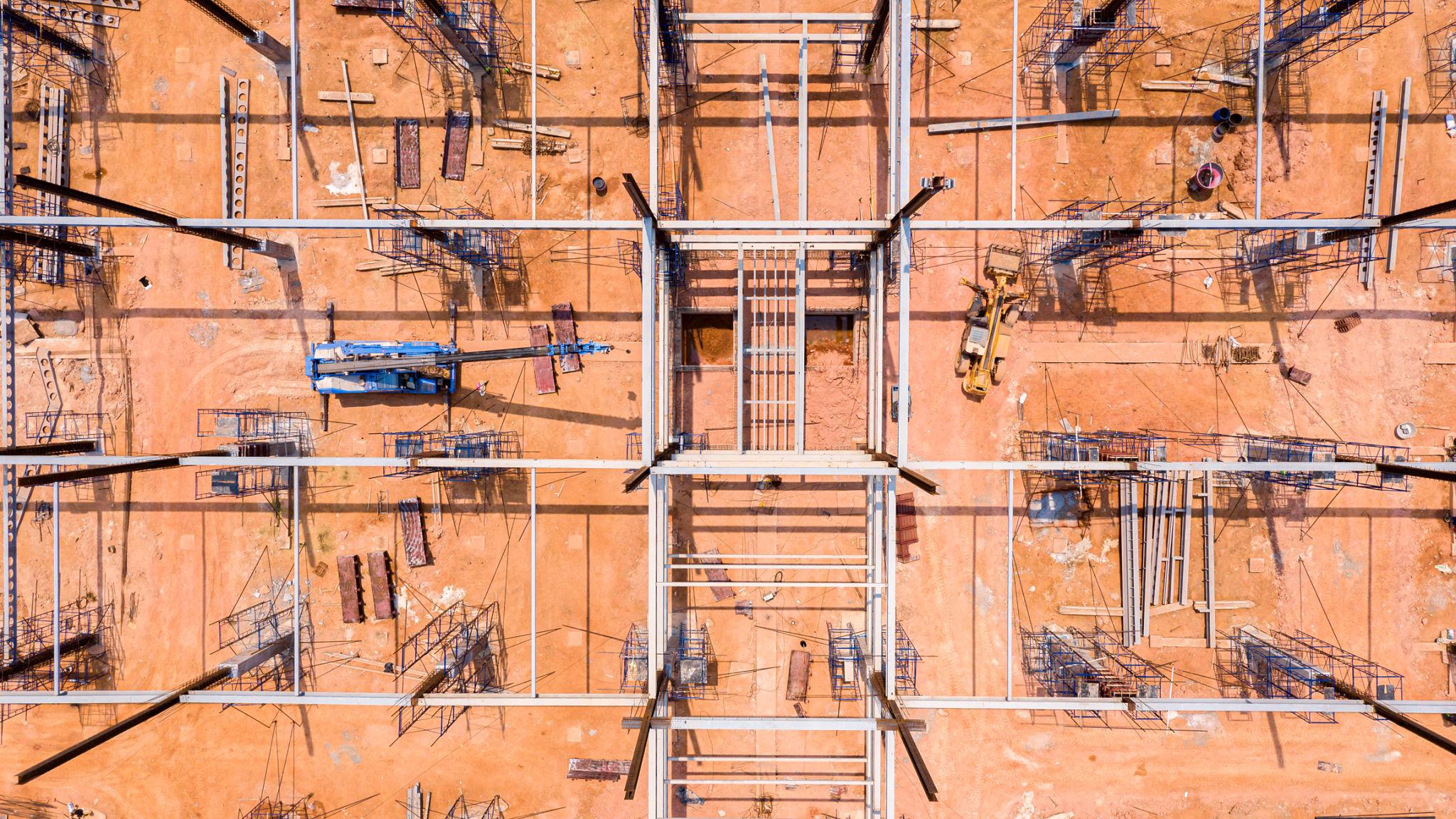 Structural steel beams arranged on fabrication site ready for industrial installation process